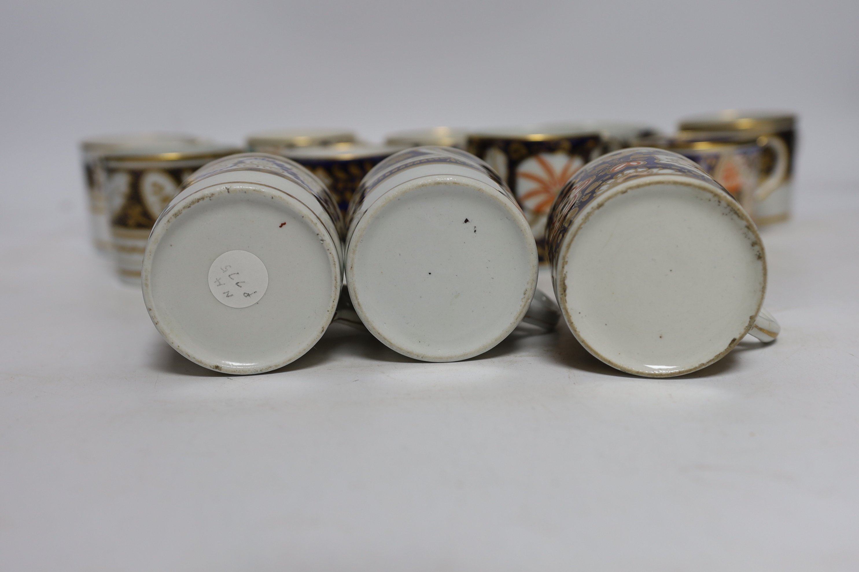 Twelve 1800-1820 English porcelain coffee cans, including Imari pattern examples